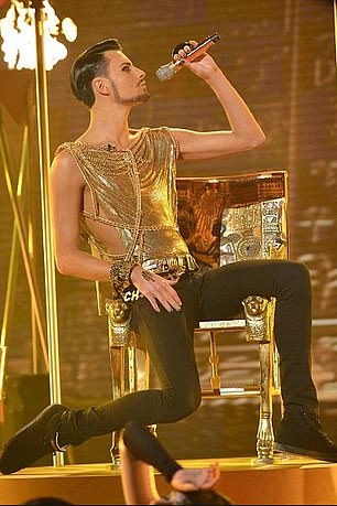 At a performance of the show, Rylan appeared in a gold lamé top and chains.