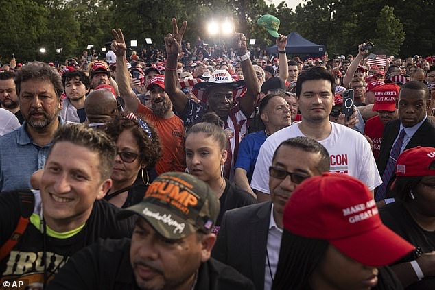 Crowds of Trump supporters listen to Trump speak in Crotona Park as the sun sets