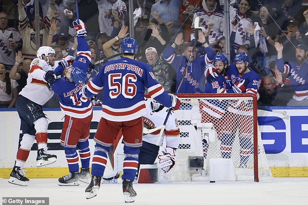 Alexis Lafreniere of the New York Rangers battles Carter Verhaeghe of the Florida Panthers