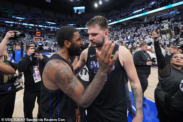 Dallas Mavericks guard Kyrie Irving (11) and guard Luka Doncic (77) celebrate Friday's victory