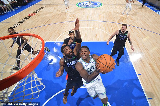 Dallas' Kyrie Irving tries to block a layup attempt by Anthony Edwards in Minneapolis