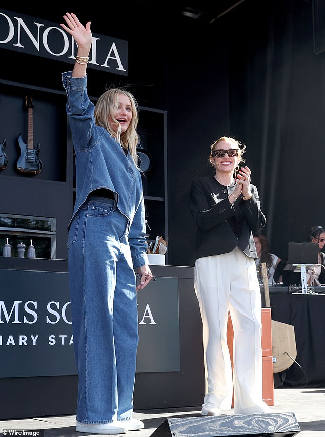 He wore a long-sleeved, loose-fitting denim shirt that left it half-unbuttoned as he waved to fans as he walked on stage.