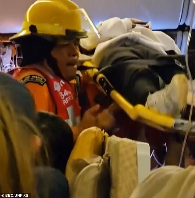 Thai rescuers rush seriously injured passengers out on stretchers