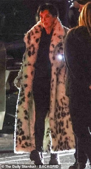 She stepped out in an ankle-length animal print coat.