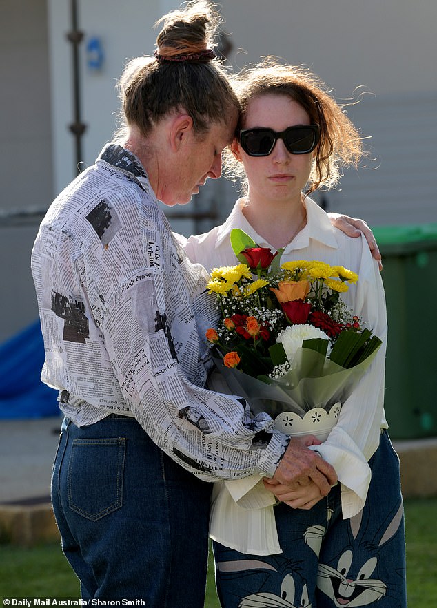 Friends of the two women tragically shot to death consoled each other outside the house