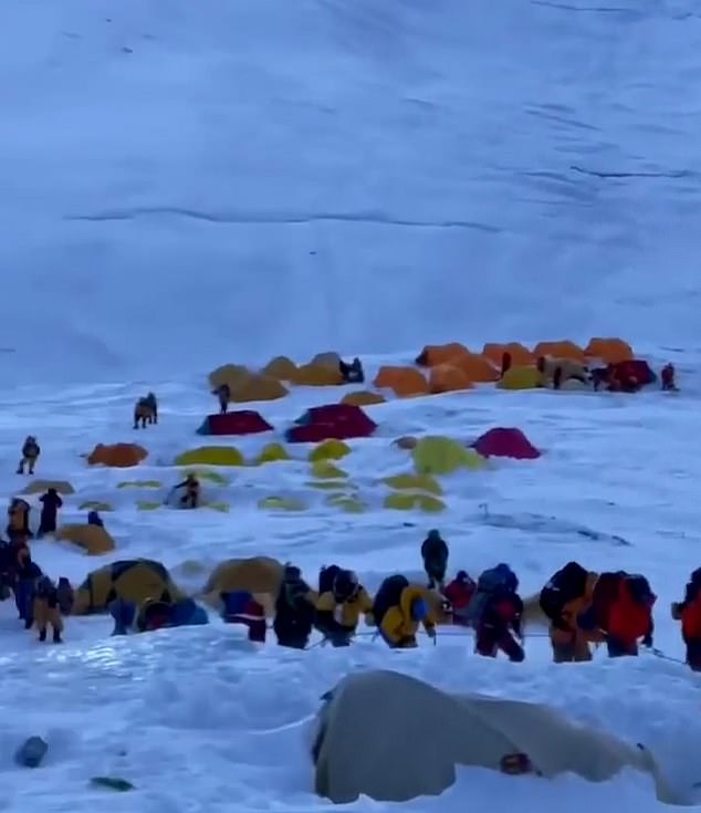 The images show the queue of climbers waiting to ascend the mountain snakes to the base camp.