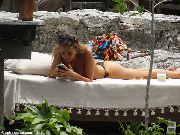 She appeared to be engrossed in her phone as she enjoyed a relaxing day in the sun.