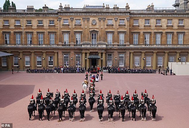 King Charles III, accompanied by the Princess Royal, presents the new sovereign banner to the Blues and Royals during a ceremony at Buckingham Palace, June 2023.