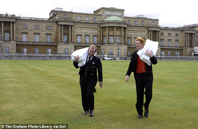 Palace staff carrying tablecloths to the royal tea shop in the gardens of Buckingham Palace, 2001