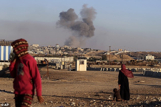 Smoke rises after an Israeli airstrike on buildings near the separation wall between Egypt and Rafah on May 7.