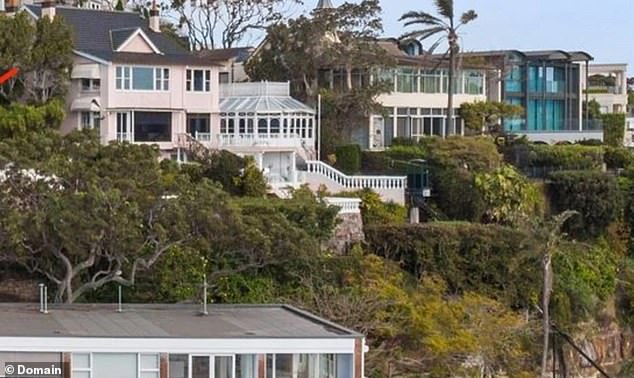 The house (centre left) has several levels extending into the waters of Sydney Harbour.