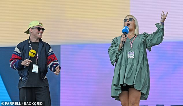 He was joined on stage by Katie Thistleton, who wore a long-sleeved green minidress with black biker shorts.