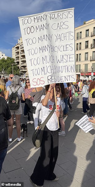 Locals held up anti-tourist banners.