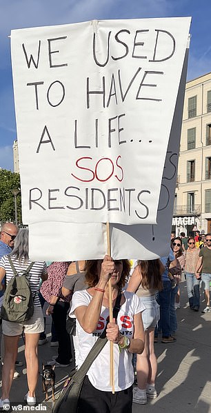 Locals held up anti-tourist banners.