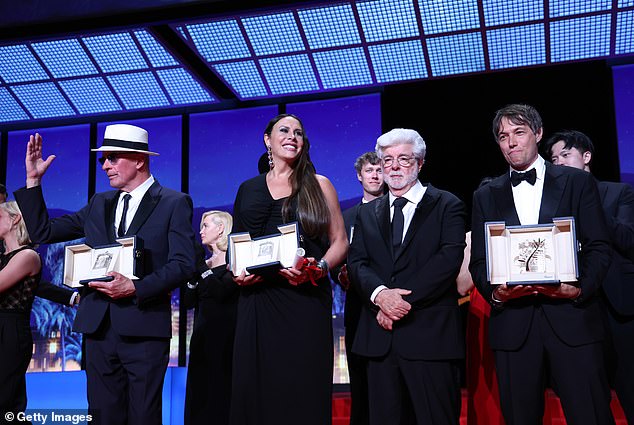 Madrid actress Karla Sofía, 52, who accepted the award, is the first trans actress to win a major award at Cannes, as she plays the title character (pictured in the middle with Jacques Audiard, George Lucas and Sean Baker) .