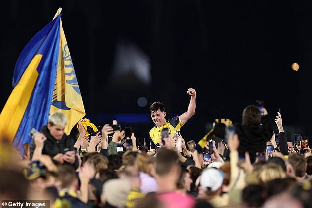 The players were surrounded by happy fans as soon as the final whistle sounded.