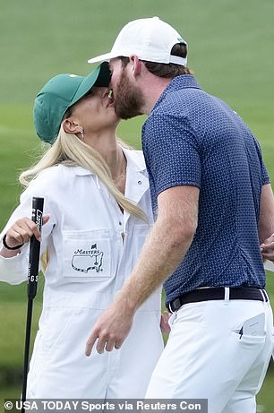 The couple kissed on the Augusta field.