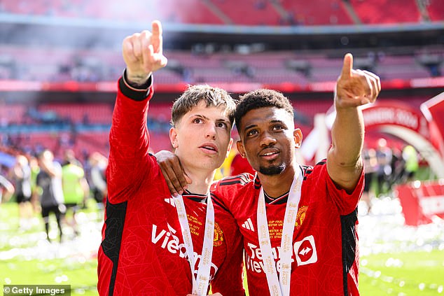 Amad Diallo (right) moved out of the way of the next champagne in the locker room celebrations after the cup final victory.