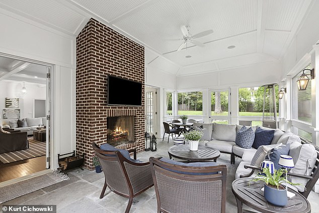 A sun-drenched family room features high ceilings and French doors leading to a cozy backyard.