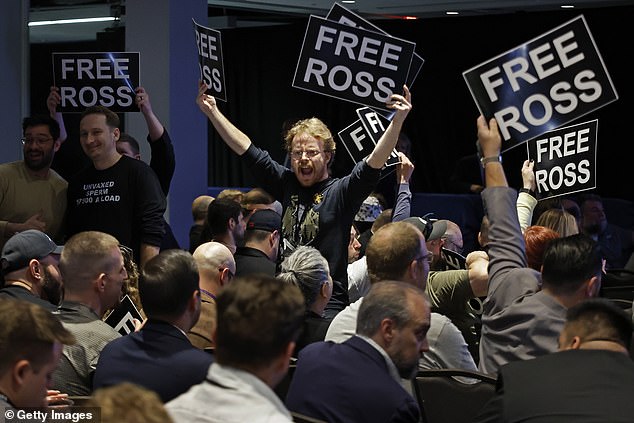 Members of the crowd stand on chairs during Saturday's Libertarian National Convention. Trump was interrupted throughout his presentation.