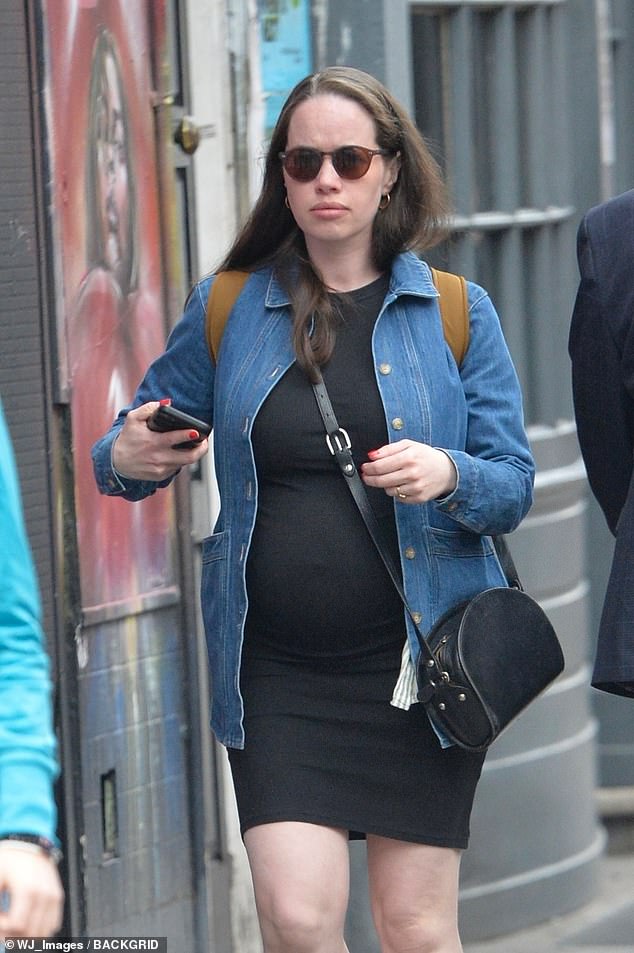 With her burgeoning baby bump and wild brunette tresses, the screen star looks drastically different from her usual tight-fitting armor and slicked-back hair look.