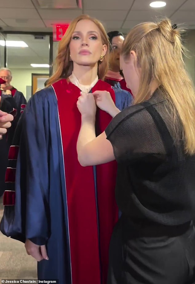 Shortly before the graduation event began, Jessica was given a navy blue gown with dark red trim and stripes on the sleeves.