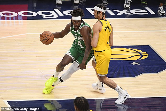 Andrew Nembhard #2 of the Pacers plays defense during the game against Jrue Holiday