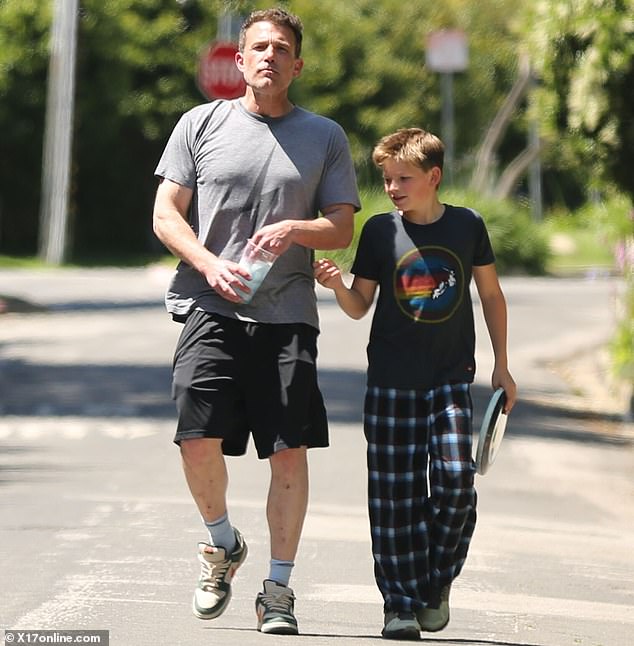 They accompanied him on a walk with his 12-year-old son, Samuel Garner, and served him dad style in a gray t-shirt with a lightning bolt and black gym shorts.