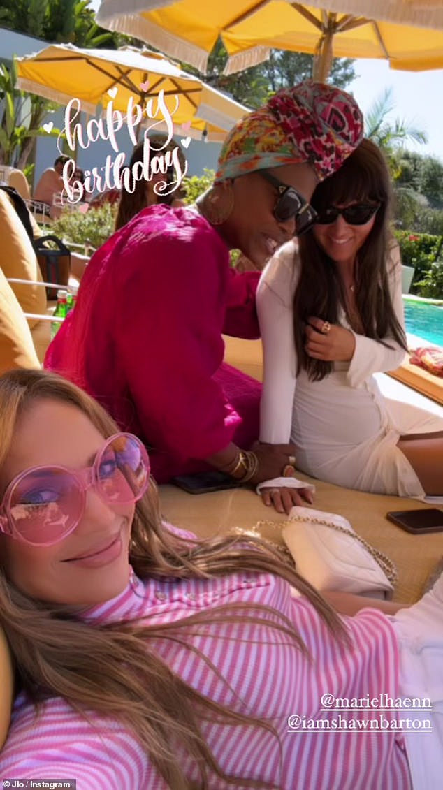 As Affleck bonded with his son, Lopez took to her Instagram to wish one of her friends a happy birthday, while she relaxed poolside in a chic pink outfit.