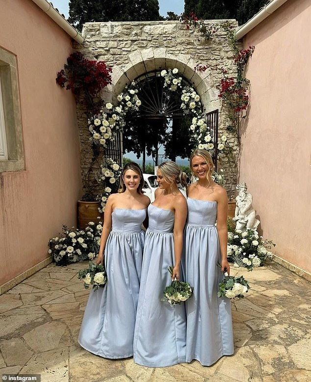 The bridesmaids looked beautiful in soft blue satin dresses and bouquets of white flowers.