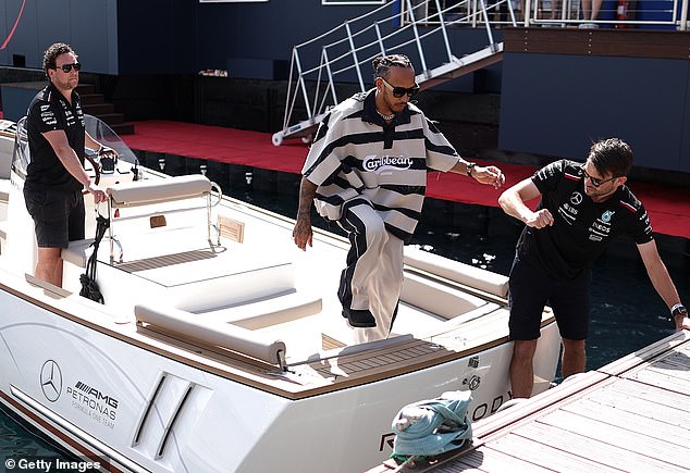 Lewis was seen jumping off a Mercedes boat when it arrived at the paddock.