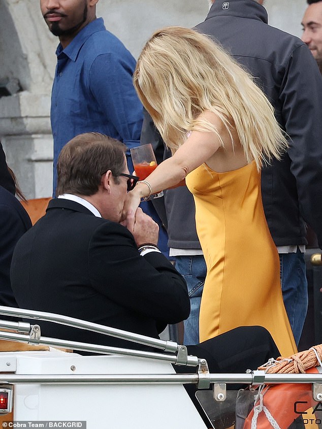 Another guest helped Sienna onto the boat and also kissed her hand.