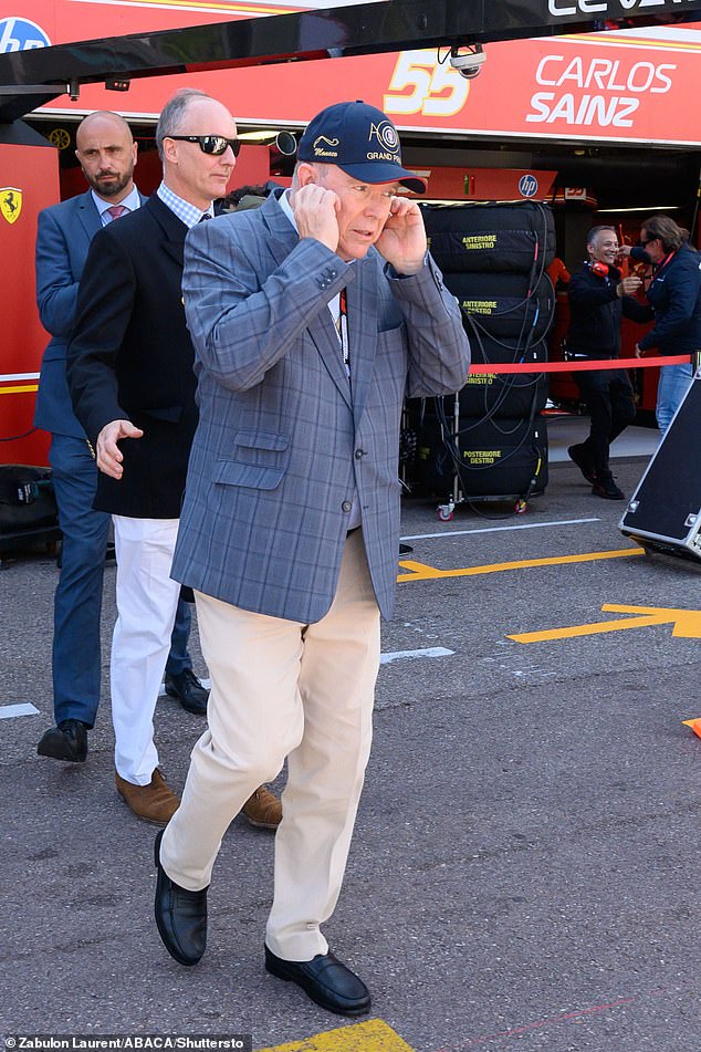 The monarch opted for cream-colored chinos and a navy blue checkered jacket and a baseball cap.