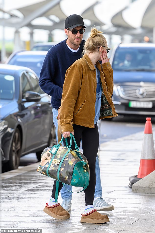 The Game of Thrones star added a brown suede jacket over the number and carried a green Louis Vuitton cabin bag.