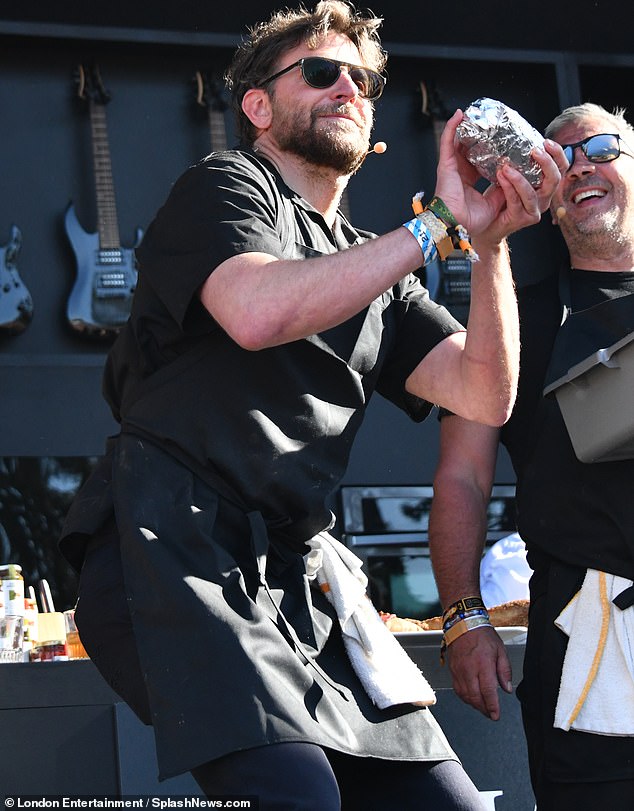 Having fun on stage with fellow pop-up food cart partner Danny DiGiampietro, the owner of Angelo's Pizzeria in South Philly, Cooper was also seen setting up his goal to throw a sandwich into the crowd, perhaps for Hadid.