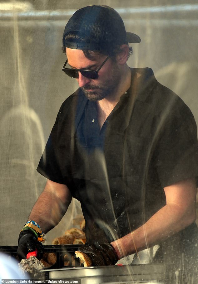 He focused on his work while preparing a Philly cheesesteak for his girlfriend and others to enjoy.