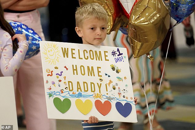 Palmer Hagerich, 4, waits for his father, Bryan, to arrive at Pittsburgh International Airport on Friday, May 24, 2024.