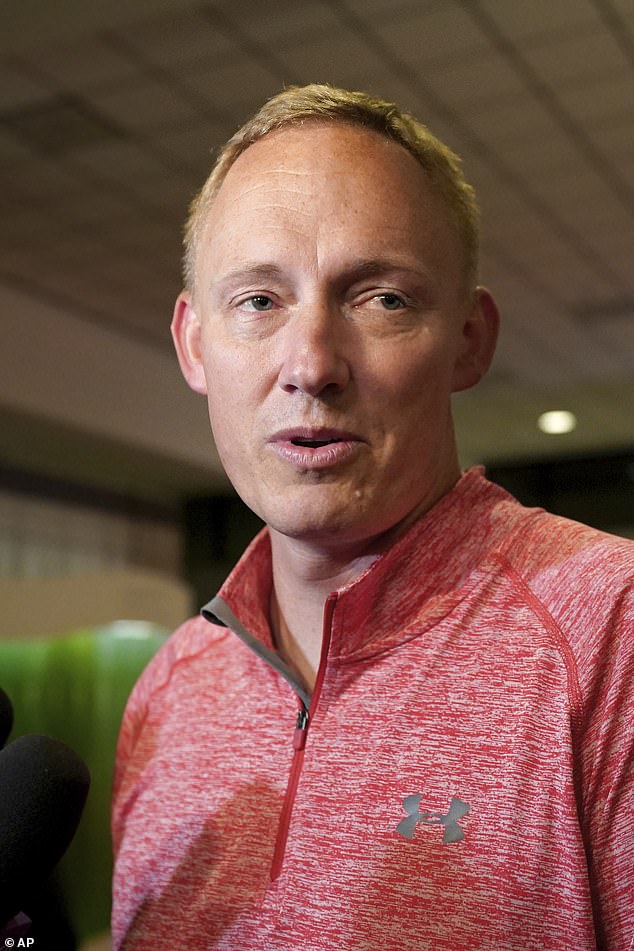 Bryan Hagerich (pictured) talks to reporters at the airport. Ryan Watson, 40, Tyler Scott Wenrich, 31, and Sharitta Shinse Grier, 45, remain stuck on the island, while Michael Lee Evans, 72, was released on bail and allowed to fly away. He returned to the United States because he suffers from a serious medical condition.