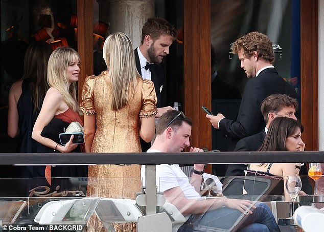 Cressida looked cheerful as she chatted with other guests at the billionaire's wedding in Venice.