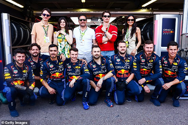 The stars posed for a group photo with the Oracle racing team.