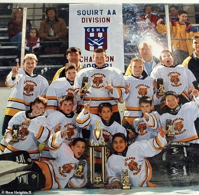 A young Kelce (center of photo) is seen holding a trophy during his urine hockey days.