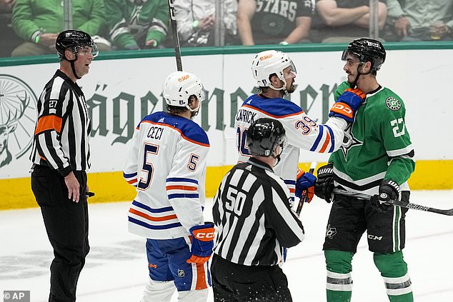 Oilers center Sam Carrick talks to Dallas Stars left wing Mason Marchment (27) in the third.