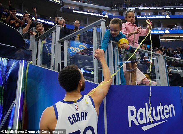 Curry is congratulated by his son Canon while his daughter Riley looks on after a win in January.