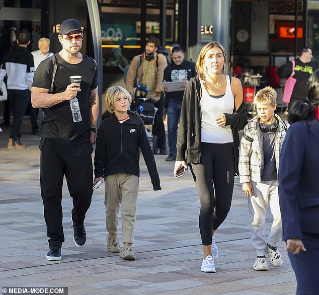 Doing his best to blend in, Chris shielded his face behind orange aviator sunglasses and wore a black baseball cap.