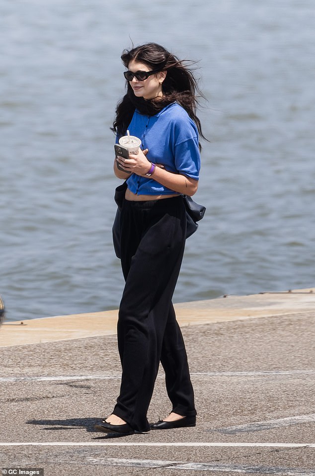 The beauty's voluminous hair flowed freely in the wind as she made her way to the jet.