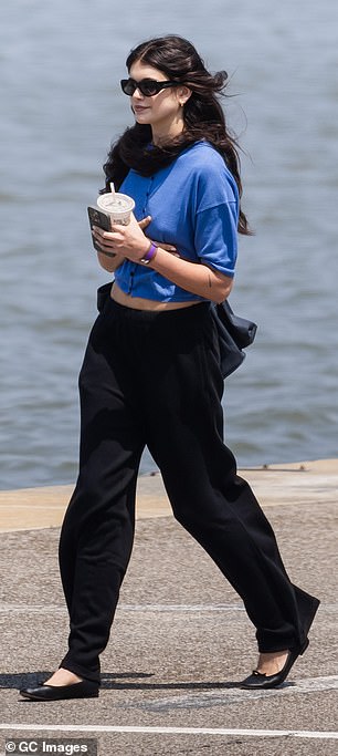 Kaia's short-sleeved button-down blouse was paired with black pants and a pair of black leather ballet flats.