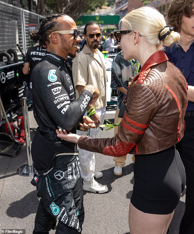 Elsewhere in the day, Anya was seen chatting to Lewis Hamilton while posing in front of his Mercedes car outside the garages.