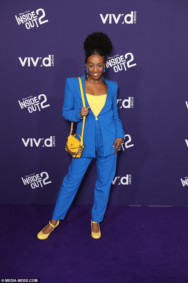 Wiggles star Tsehay Hawkins (pictured) chose an electric blue outfit with striking yellow details, including a blouse, bag and heels in sunny hues.