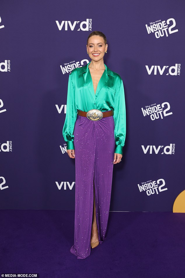 Neighbors actress April Rose Pengilly (pictured) looked brilliant on the night in a green silk blouse paired with the unusual choice of a brown denim belt and a bright purple skirt.