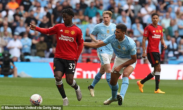 Mainoo, pictured holding off Rodri at Wembley, shone in the heart of the United team.